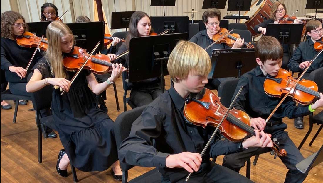The youth orchestra performs onstage.