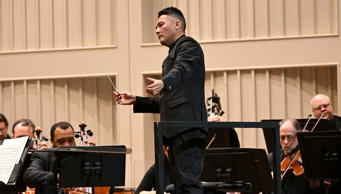A conductor orchestrates Symphonie Fantastique