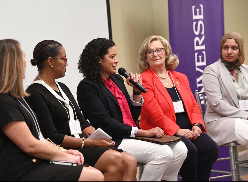 A group of panelists speak to Converse University guests at the leadership conference.